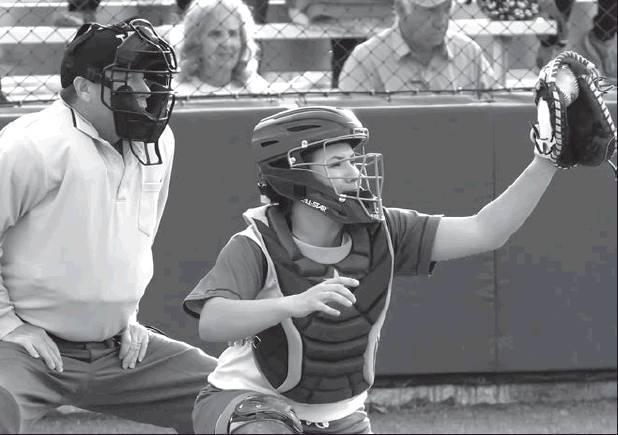 Above, Madison Kelm takes care of business behind the plates against Bremond Tuesday night. The Lady Dogs swept the Lady Tigers 15-0.